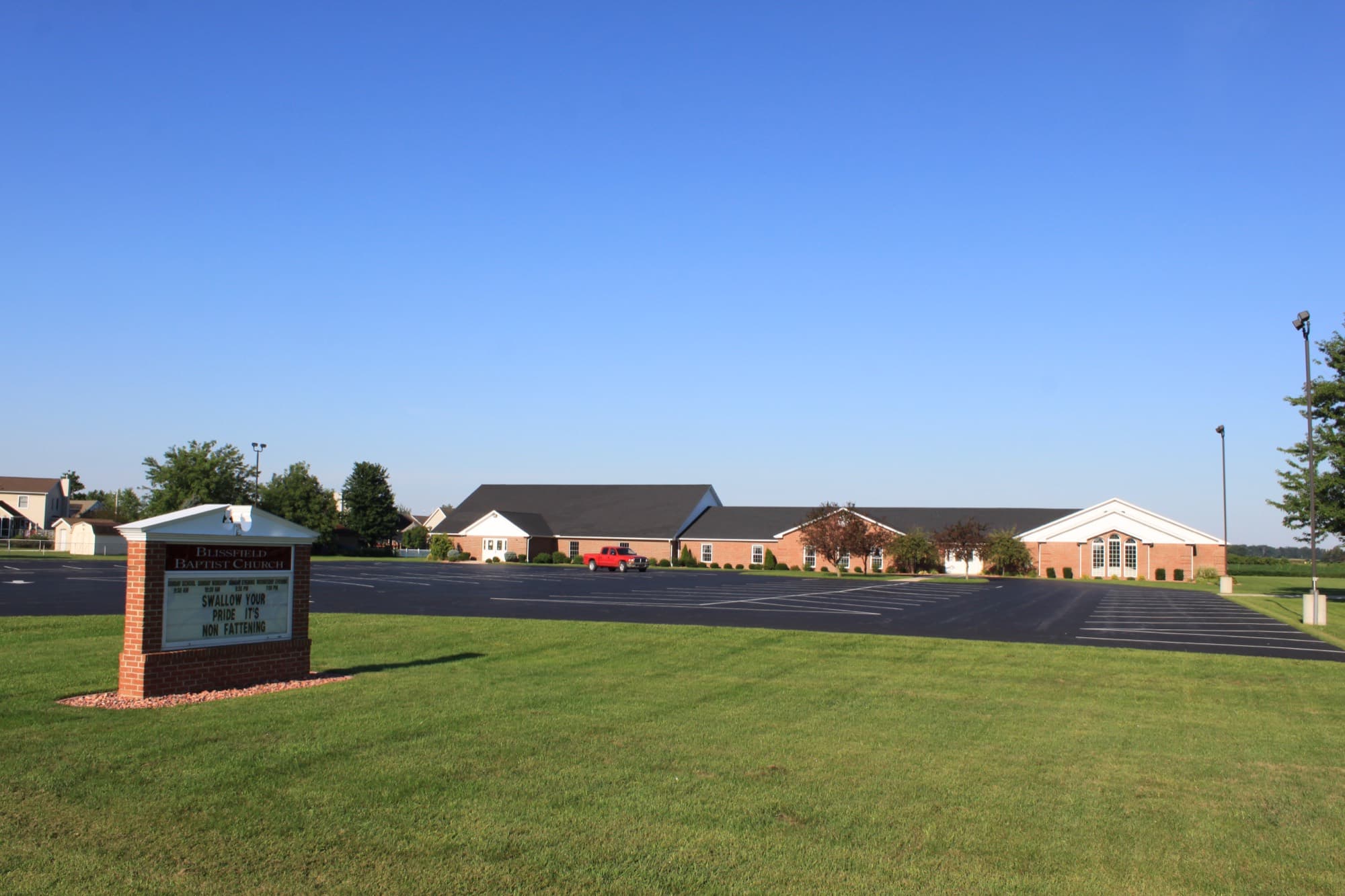 The Blissfield Baptist Church sign and building on N Monroe St