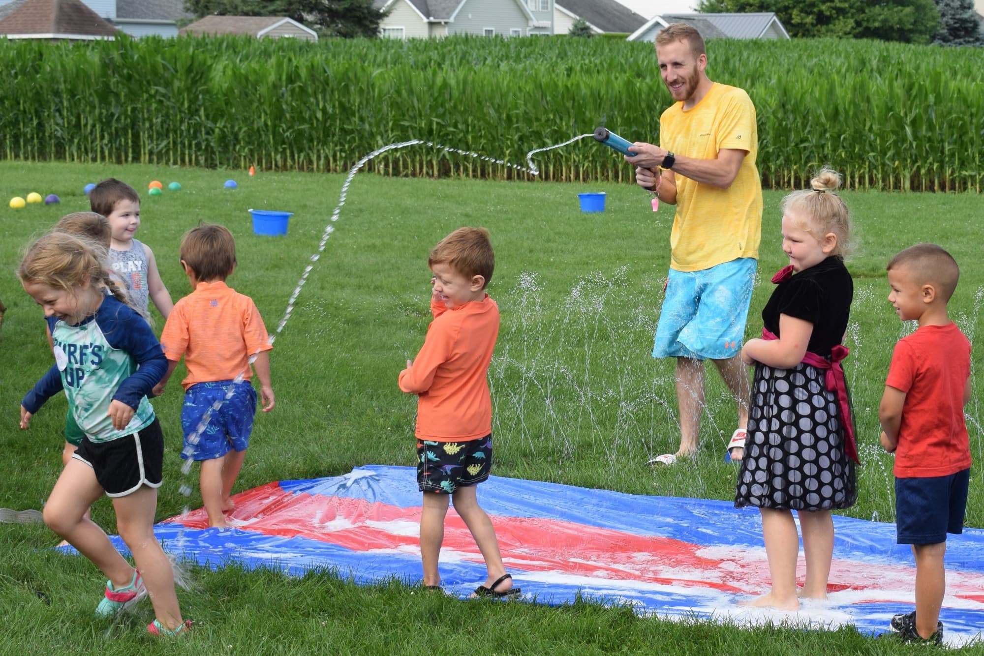 Children on the water slide behind the church